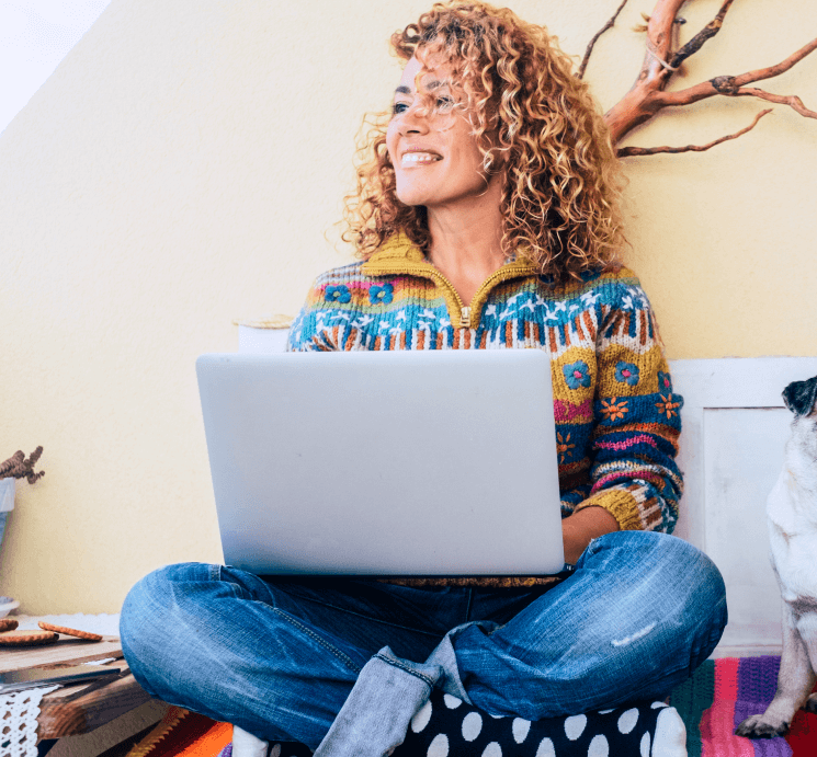 Woman sitting cross-legged while working on a laptop | Feature image for the Anxiety Hypnotherapy Melbourne page on Hypnofit.