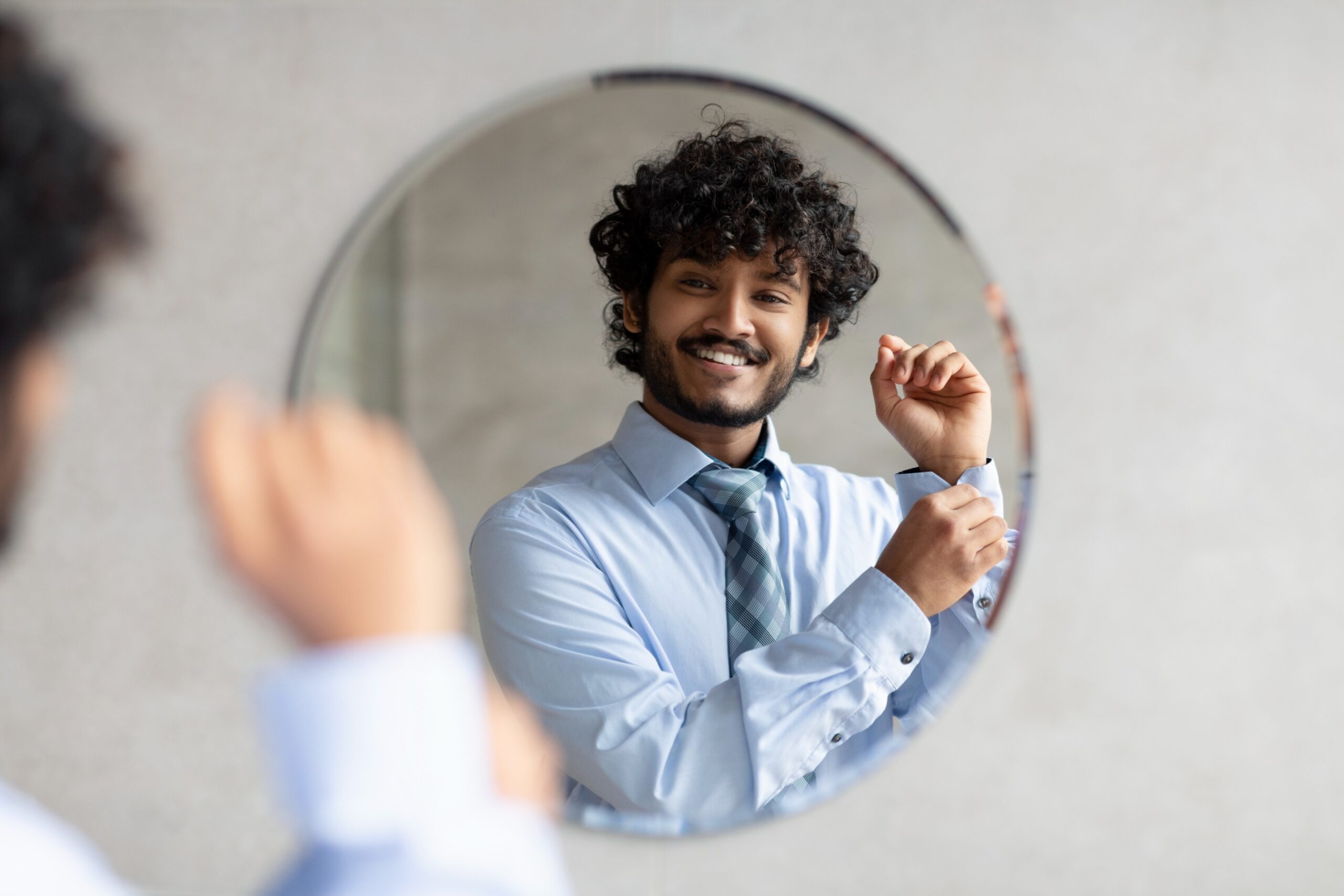 Man looking confidently in the mirror